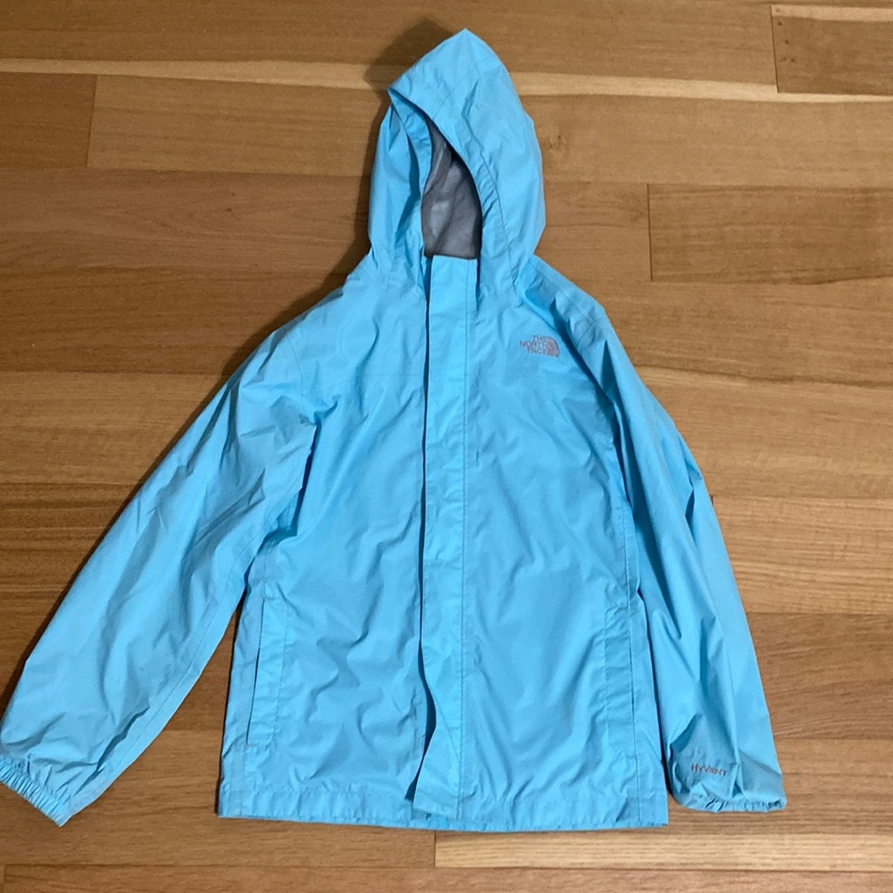The North Face Hyvent youth large (YL) light blue rain jacket with hood.